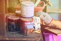 Several paint cans, old indoor gloves, old paint brushes