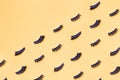 Several pairs of different false eyelashes on a yellow