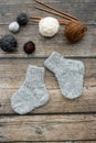 Several pairs of woolen newborns socks, on dark background