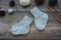 Several pairs of woolen newborns socks, on dark background