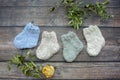 Several pairs of woolen newborns socks, on dark background