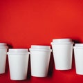 Several paper cups on red background