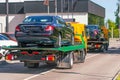 Several passenger car evacuation loaded onto a recovery truck for transportation, back view Royalty Free Stock Photo