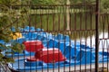 Several pedal boats moored at the shore as seen through the bars Royalty Free Stock Photo