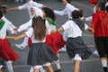 several people dancing around on a sidewalk together in costumes and boots