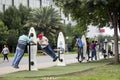 Several people exercising in a fitness area of a public park.