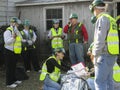 Several people helping the injured person close up image.