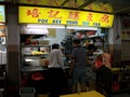 Several people order their food in a restaurant in a typical food court or Hawker of Singapore