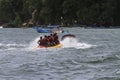 Several people are riding a banana boat on Pangandaran beach Royalty Free Stock Photo