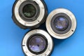 Several photographic lenses lie on a bright blue background. Spa Royalty Free Stock Photo