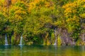 Several picturesque waterfalls, falling in a karst lake with emerald water. Autumn in Croatia. Travel to the Plitvice Lakes. The