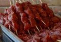 Several pieces of beef, chopped into cubes, seasoned with salt, garlic, pepper, skewered on wooden skewers, placed inside an