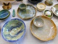 Several pieces of colorful ceramic clay wares like plates bowls and trays