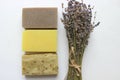 Several pieces of handmade soap and a bouquet of lavender flowers on a white background