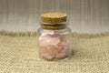 Several pieces of polished pink quartz on glitter pink background. Minimal color still life photography Royalty Free Stock Photo