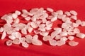 Several pieces of polished pink quartz on red background. Narrow focus line, shallow depth of field front view Royalty Free Stock Photo