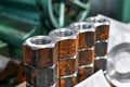 Several piled-up rusty nuts lie in the workshop