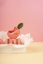 Several pink macaroons cakes one of which is bitten and decorate