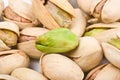 Several pistachio nuts naked and in shell close up