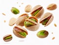 Several pistachios are scattered across a clean, white background, some whole and some partially open Royalty Free Stock Photo