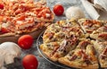 Several pizzas on a dark background. Mushroom pizza and chicken pizza.