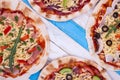 Several pizzas on striped background