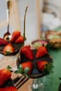 several plates are holding chocolate cakes, strawberries and berries Royalty Free Stock Photo