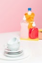 Several plates, a kitchen sponges and a plastic bottles with natural dishwashing liquid soap in use for hand dishwashing Royalty Free Stock Photo