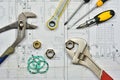 Plumber`s tools on an architectural plan of a house Royalty Free Stock Photo