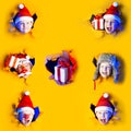 Several portraits little cheerful Santa in hat smiles, getting out of the ragged yellow background lit by neon light. Large size Royalty Free Stock Photo