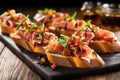 several prosciutto bruschetta pieces arranged in a row