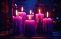 several purple candles lit on the dark background Royalty Free Stock Photo