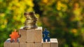 Several puzzles climb to the top of the pyramid made of wooden blocks. The concept of achieving business goals 