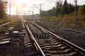 Several railway tracks going into the distance, illuminated by the setting sun. Arrows paths, turn. Autumn landscape