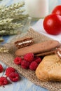 Several raspberries cereal biscuits on jute