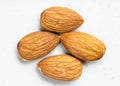 Several raw almond seeds close up on gray Royalty Free Stock Photo