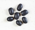 Several raw mexico black beans close up on gray c