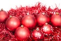 Several red Christmas baubles and tinsel isolated Royalty Free Stock Photo