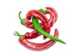 Several red and one green chili peppers on light background Royalty Free Stock Photo