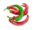 Several red and one green chili peppers on light background Royalty Free Stock Photo