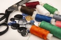 Several reels of multicolored sewing thread, multicolored buttons of different sizes, and large vintage sartorial scissors on a Royalty Free Stock Photo