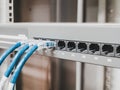 Several RJ45 Ethernet cables plugged into a switch inside a server rack of a company to link computer together into a network. Royalty Free Stock Photo