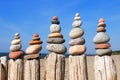 Several Rock zen pyramids of colorful pebbles on a beach on the background of the sea. Concept of balance, harmony and meditation