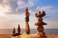 Several Rock zen pyramids of colorful pebbles standing on the beach, on the background of the sea. Concept of balance, harmony and Royalty Free Stock Photo