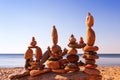 Several Rock zen pyramids of colorful pebbles standing on the beach, on the background of the sea. Concept of balance, harmony and