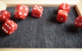 Several rolling red dice fall on special boardgame frame