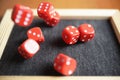 Several rolling red dice fall on special boardgame frame