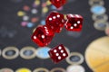 Several rolling red dice fall on a table with boardgame. Gameplay moments Royalty Free Stock Photo