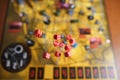 Several rolling red dice fall on a table with boardgame. Gameplay moments Royalty Free Stock Photo