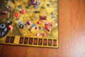 Several rolling red dice fall on a table with boardgame. Gameplay moments